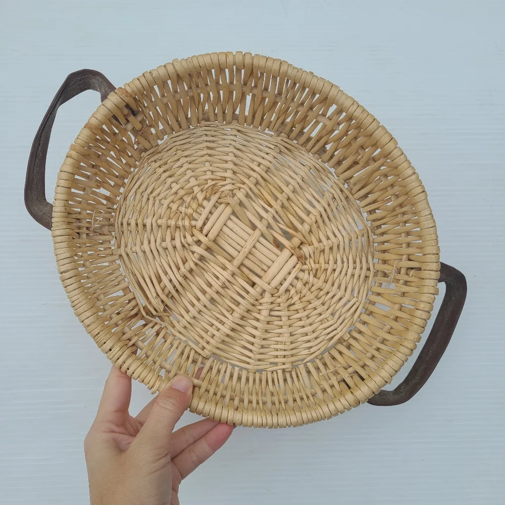 Woven wicker basket with faux leather handles